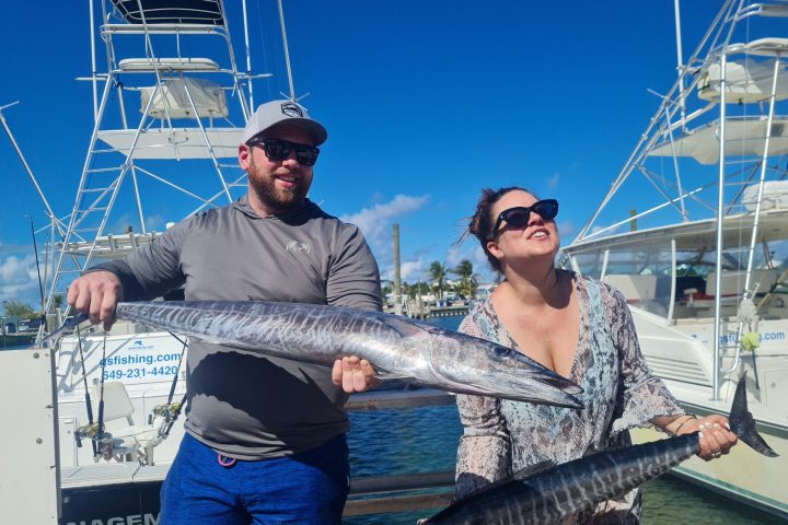 a person holding a fish on a boat