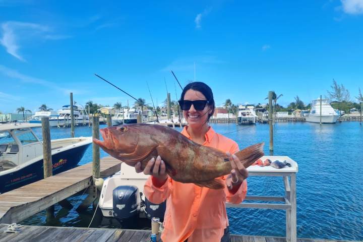 a man holding a fish in the water