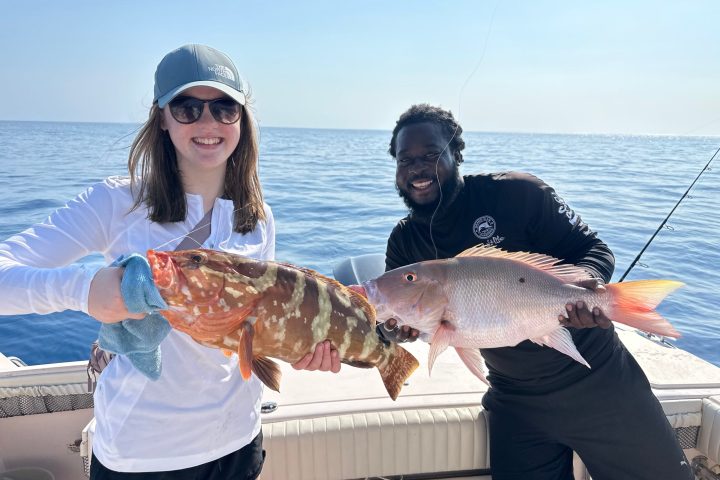 a woman holding a fish in the water