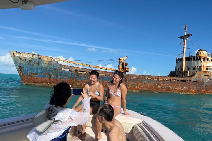 a man and a woman sitting on a boat in the water
