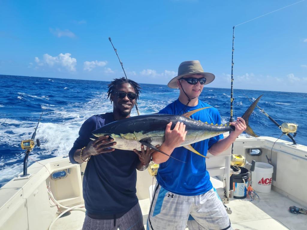 a person holding a fish in the water