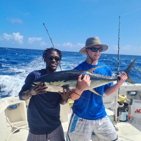 a person holding a fish in the water