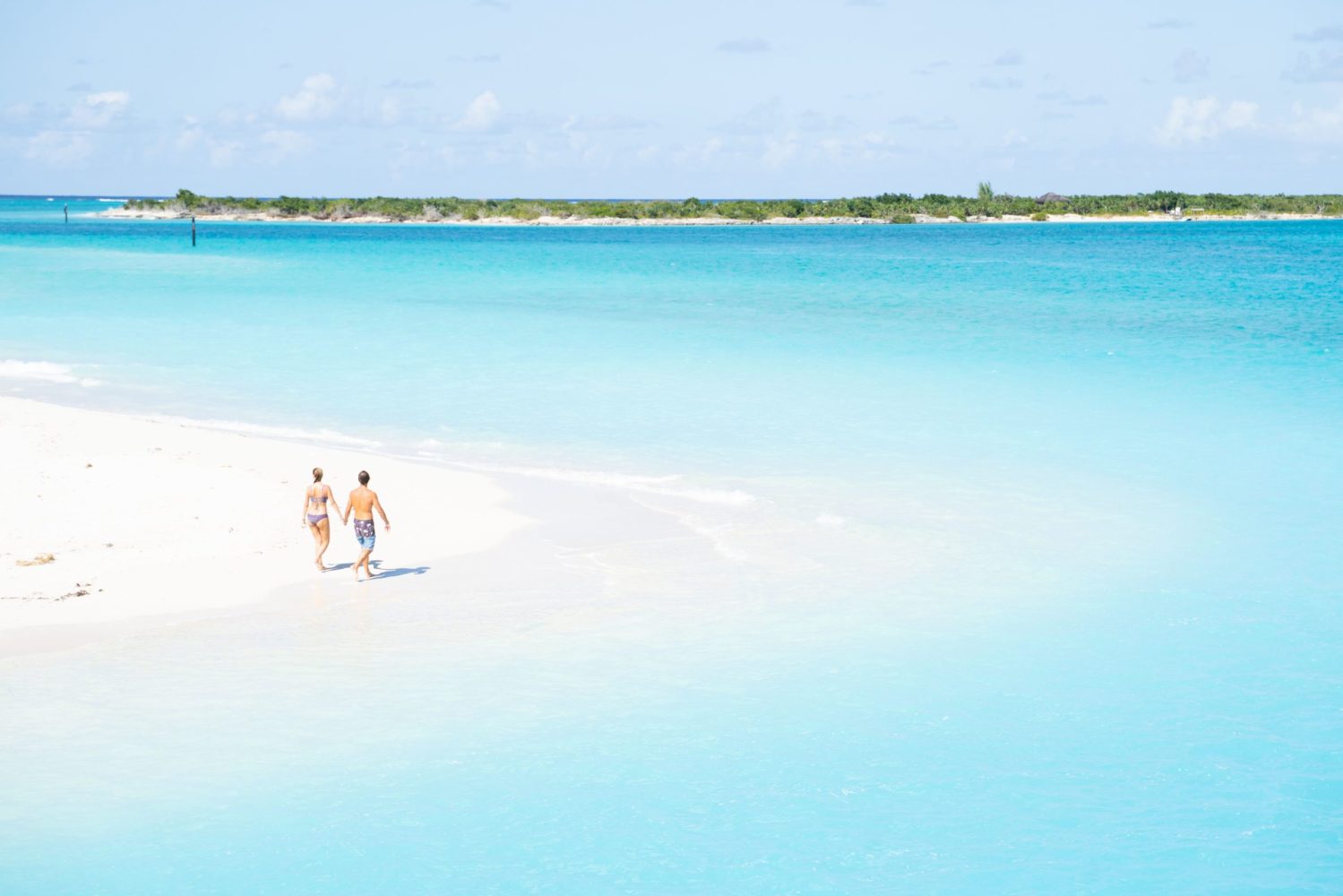 a man standing next to a body of water