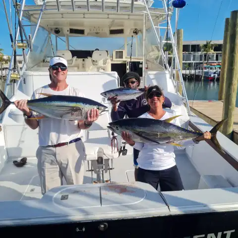 a person holding a fish on a boat