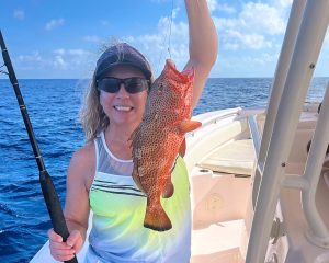 a person standing next to a body of water