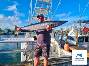 a man standing on a boat in the water
