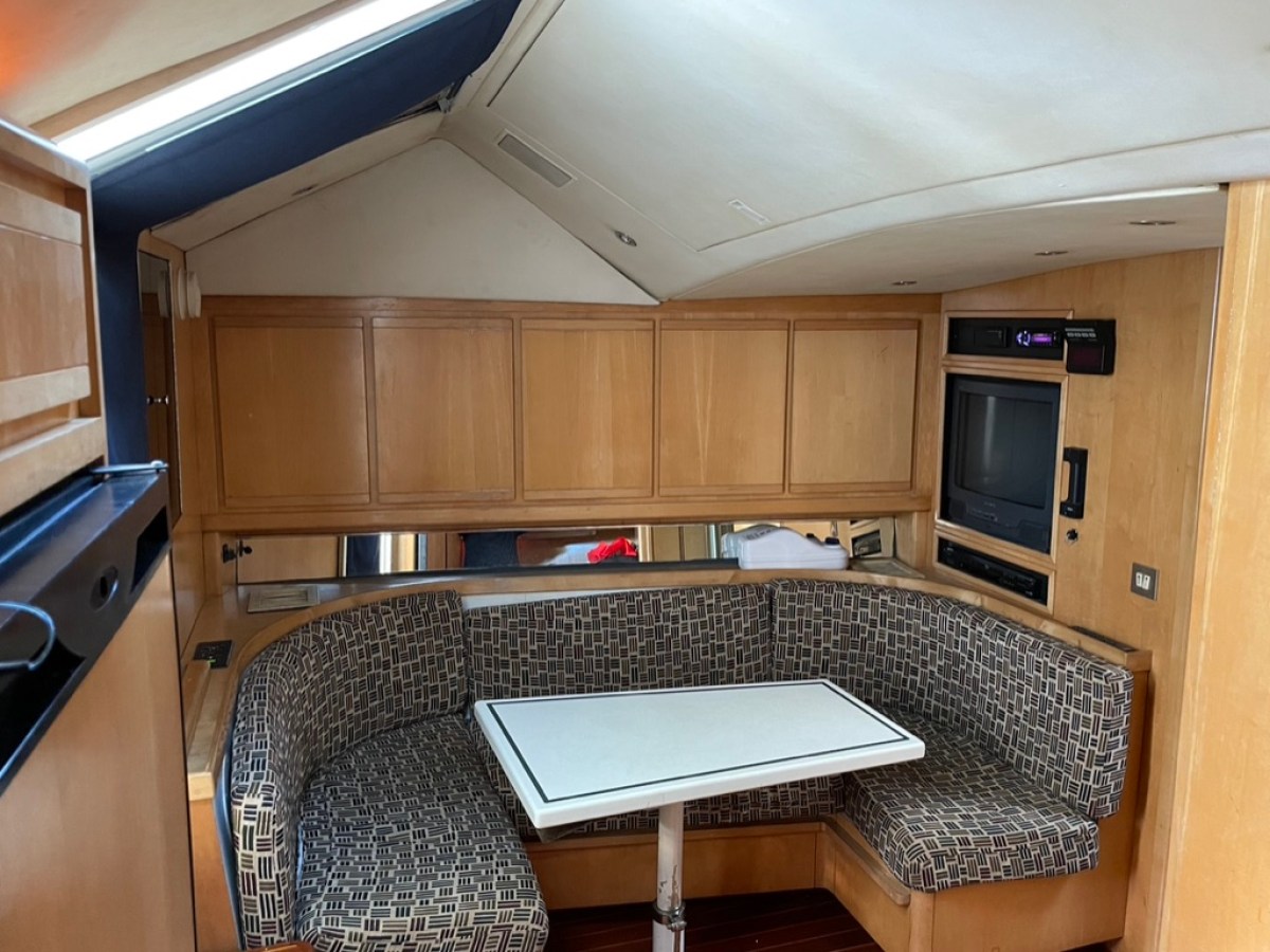 a kitchen with wooden cabinets and a microwave
