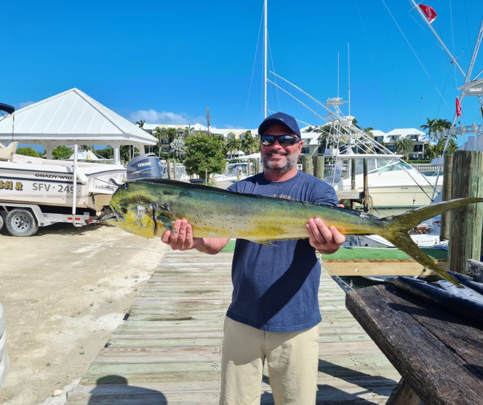 a man holding a fish