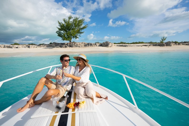 a person sitting in a boat on a body of water