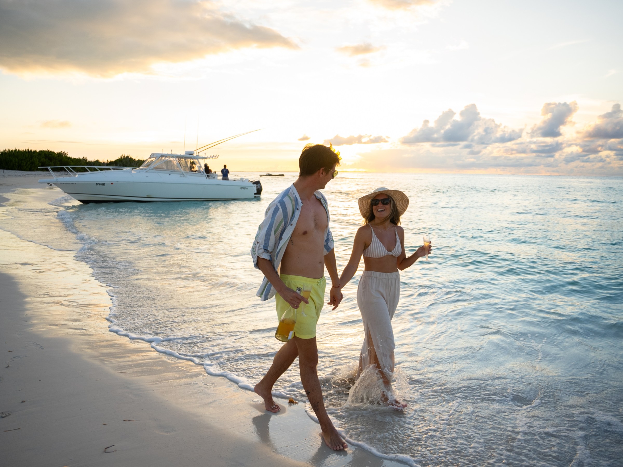 a man standing on a beach near a body of water